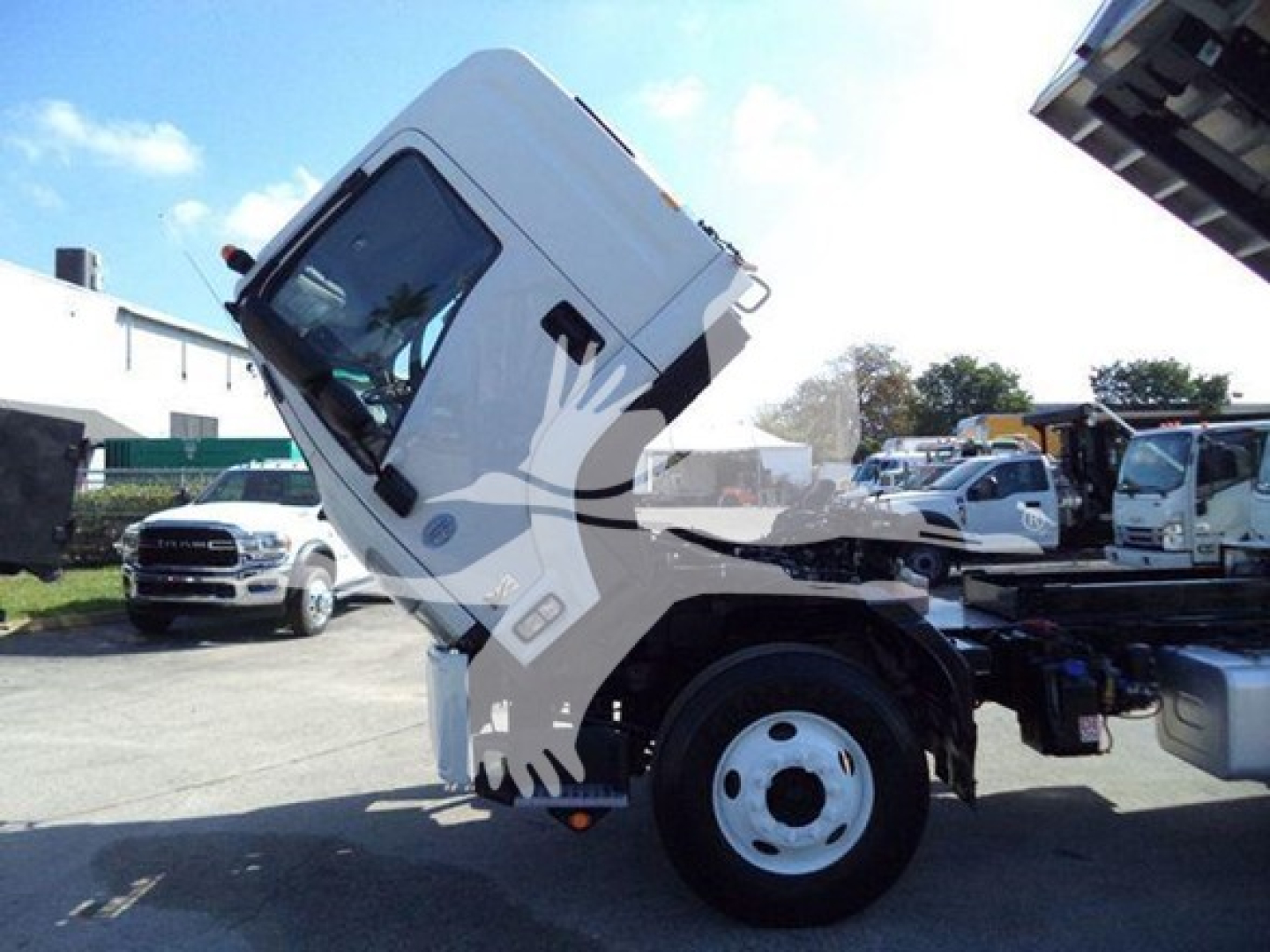 Isuzu FTR cab and chassis showing up-right tilted cab with wheel and chassis components visible
