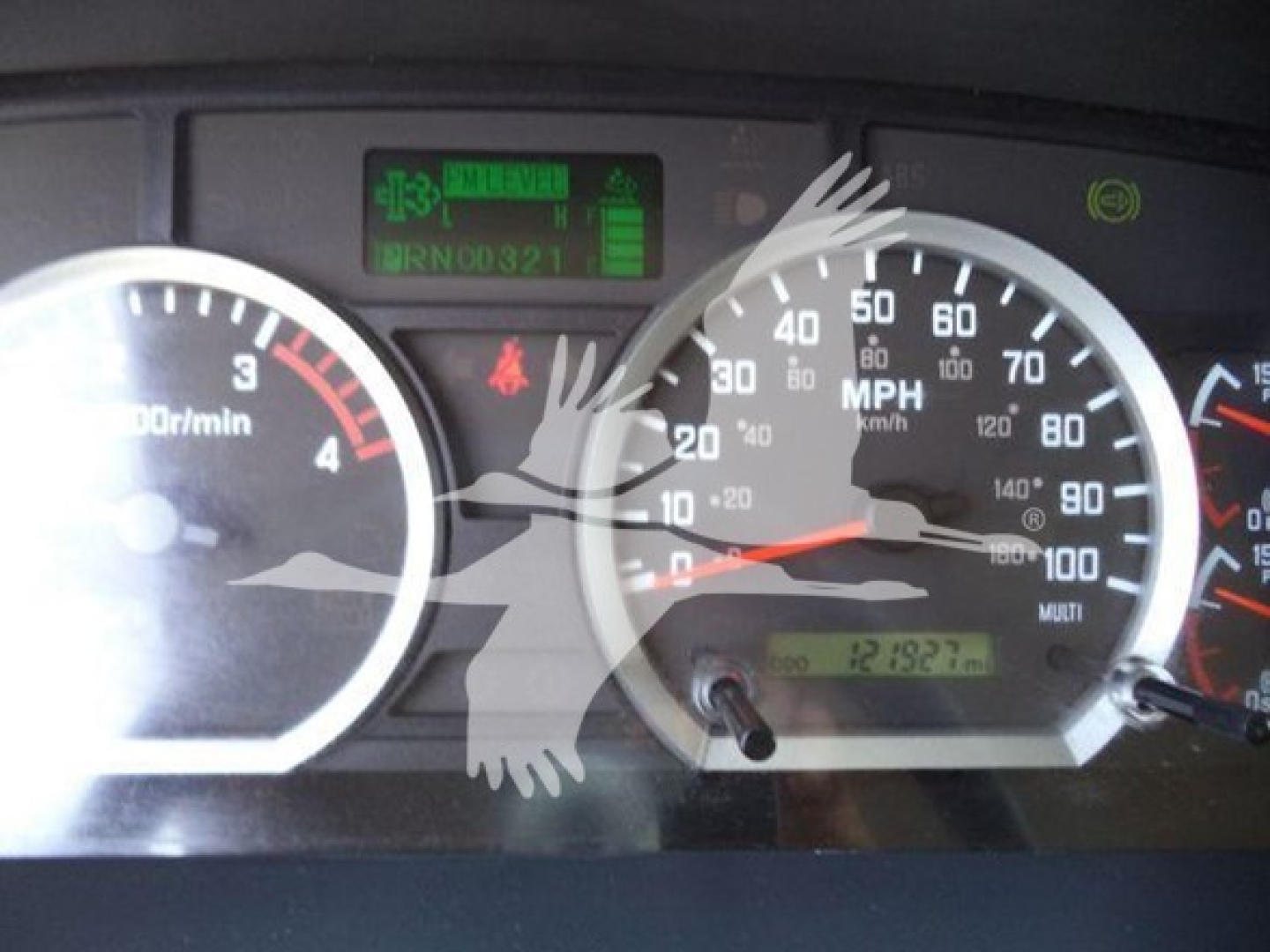 Isuzu FTR dash showing tachometer, speedometer, and green warning/indicator display with VIN-like text and odometer readout.