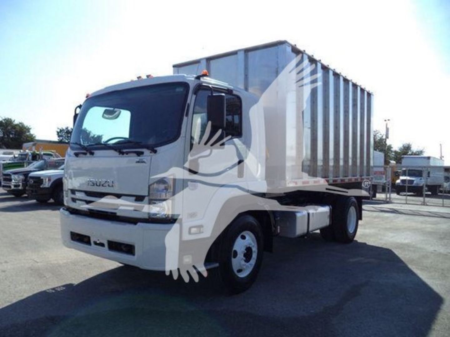 Isuzu FTR truck with a large metal dumping body, front cab visible, chipper category. No legible small text visible on components.