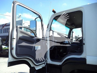 Isuzu FTR cab interior and door area with open driver door, showing cabin interior and seating.