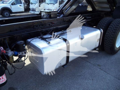 Isuzu truck chassis showing a large rectangular fuel tank mounted along the frame with hoses and components nearby.