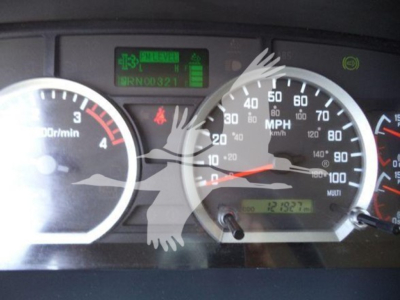 Isuzu FTR dash showing tachometer, speedometer, and green warning/indicator display with VIN-like text and odometer readout.