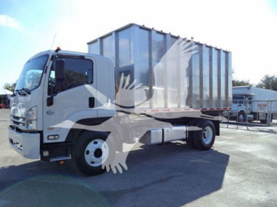 Isuzu FTR truck with large steel chipper body mounted, side view showing cab and chassis.