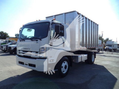 Isuzu FTR truck with a large metal dumping body, front cab visible, chipper category. No legible small text visible on components.