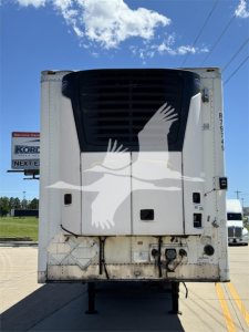 Rear view of a 2011 Wabash reefer trailer with a large black cooling unit and white body, lower rear doors, and bumper hardware visible.