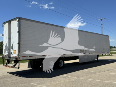 Trailer side view of a 2011 Wabash reefer trailer showing a two-axle configuration with a gray exterior and reflective markings.