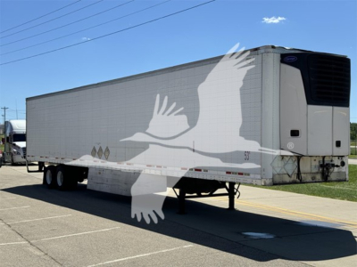 Wabash reefer trailer showing side decals and refrigeration unit at front-right, three-axle with tandem wheels, raised landing gear.