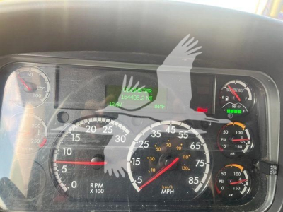 Dashboard of a 2019 Freightliner M2 106 showing gauges, digital readout, and warning icons in a moving-van truck interior.
