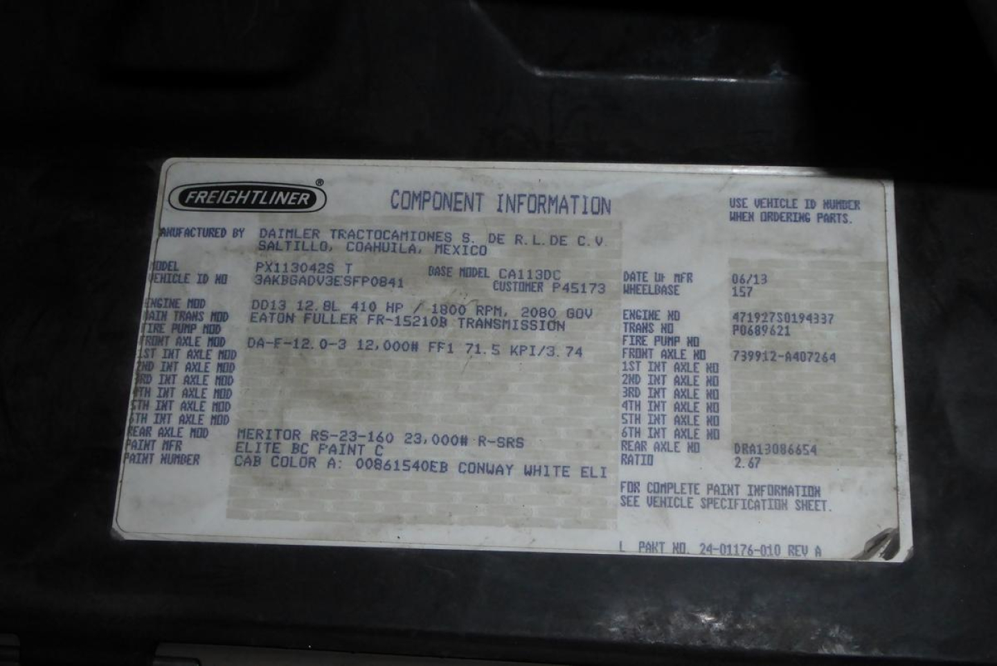 Freightliner label with component information on a truck engine bay. The plate includes Manufacturer: Freightliner, Model, VIN 3AKBGADV3ESFP0841, and various codes and weights.
