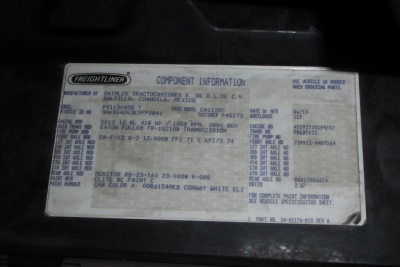 Freightliner label with component information on a truck engine bay. The plate includes Manufacturer: Freightliner, Model, VIN 3AKBGADV3ESFP0841, and various codes and weights.