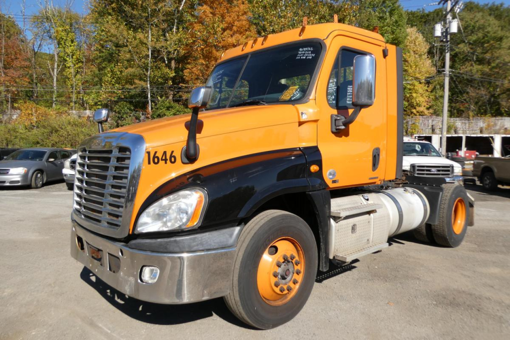 Freightliner Cascadia 125 daycab truck front-left view showing orange cab and black fenders with VIN 1FUBGEDVXCLBK4301 not visible on image