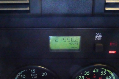 Dashboard of a Freightliner Cascadia 125 showing an hour meter reading 215?56?2 hours on the digital display and a BRAKE indicator to the right.