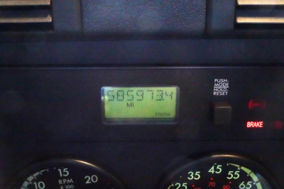 Dashboard view showing engine hour meter reading 685,?4? miles and gauge clusters in a Freightliner Cascadia 125 daycab.
