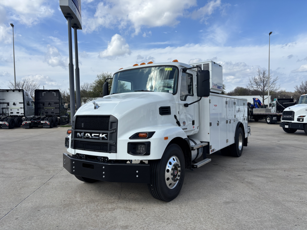 Service/utility truck shown from front-left angle with white cab and utility body, Mack MD7 chassis, text visible on grille and utility compartments.