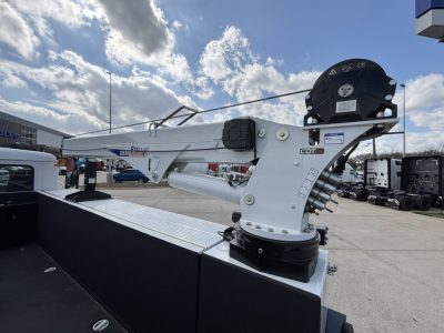 Mack MD7 crane/well-mounted boom assembly in truck bed with hydraulic rotation and control platform visible.