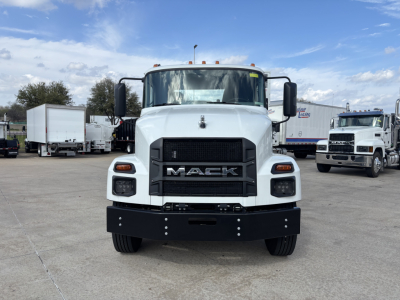 Mack MD7 truck front view showing bold grille with MACK letters and large black bumper.