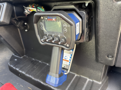 Panel view showing a Stealth electronic device mounted in a Mack MD7 cab, with cables, wiring, and diagnostic tool connected; blue adapter and control panel visible.