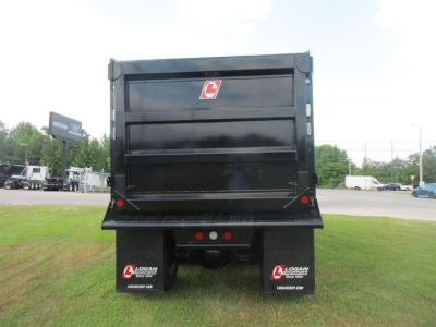 Dump truck rear view showing cargo bed and rear Mud flaps with logo, tail lights, and bumper on a Western Star 49X chassis.