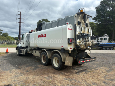 Freightliner 108SD vacuum truck with Vacall branding, tanker body, rear hoses and equipment visible.