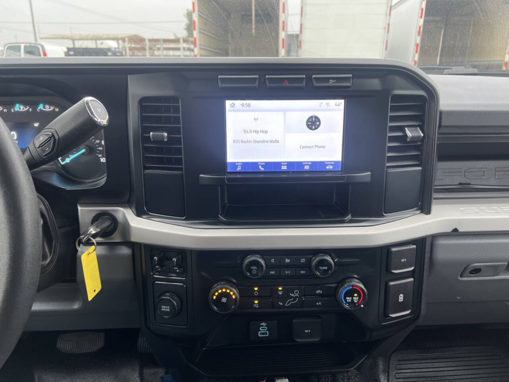 Ford F-550 dashboard and center console view showing infotainment screen and climate controls in-service truck.
