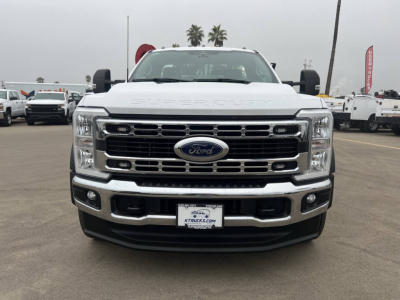 Ford F-550 front view showing Ford emblem, chrome grille, and bumper; headlamps and fog lamps visible; license plate area with dealership plate.
