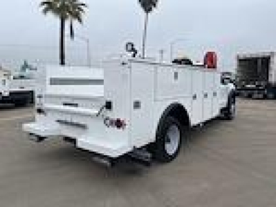 Ford F550 service/utility truck rear-left view showing utility compartments and dual rear wheels.