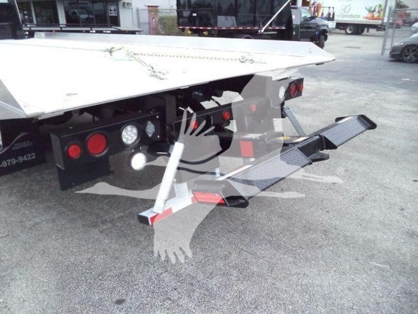 Rear view of Freightliner M2 106 rollback utility bed showing tail lights and rear frame.