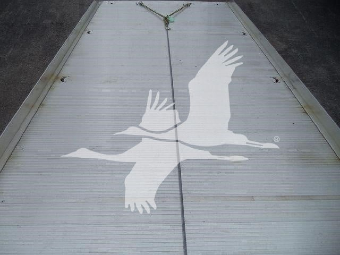 Fleet-labeled freight trailer deck showing a white Alaska style logo with two birds in flight.