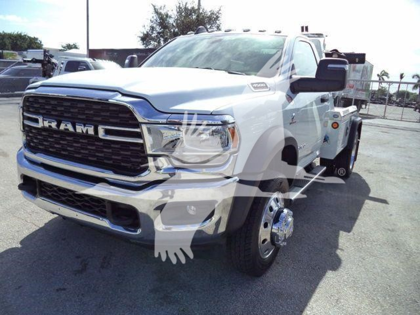 Ram 4500 tow truck front-left view showing chrome grille with RAM lettering, large headlights, side mirrors, and dual rear wheel; white exterior; winch category listing.