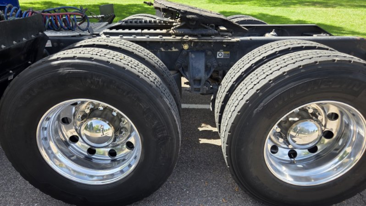 Dual rear wheels showing tire treads and chrome wheel hubs on a Kenworth truck chassis