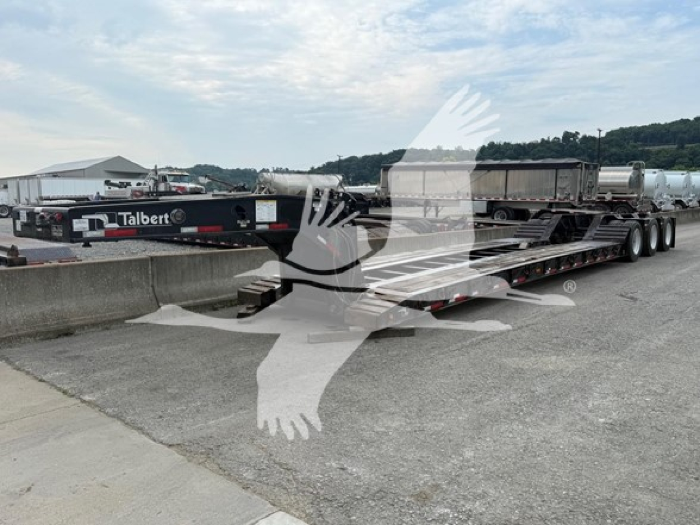 Talbert 55CC lowboy trailer with multi-axle deck showing brand decals and flatbed sections.
