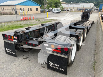 Talbert 55CC lowboy trailer viewed from rear-left, showing dual axle setup with white rims, taillights, and mudflaps reading 'TRI-STATE TRAILER SALES'