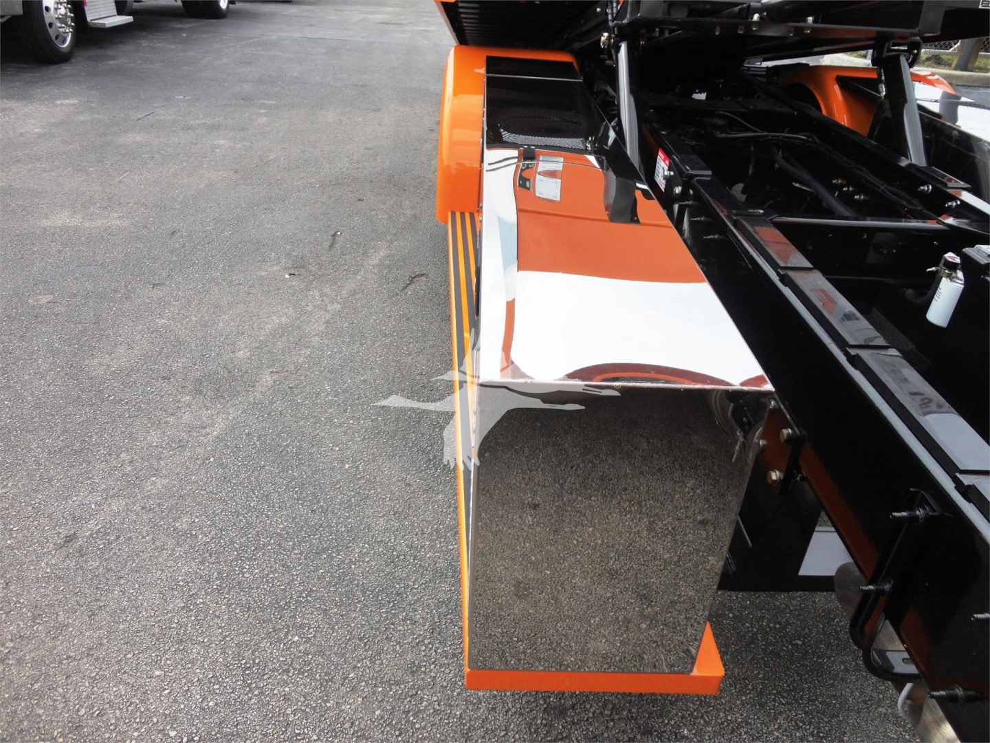 Peterbilt 337 rollback truck showing side mirror and orange-white reflective panel.