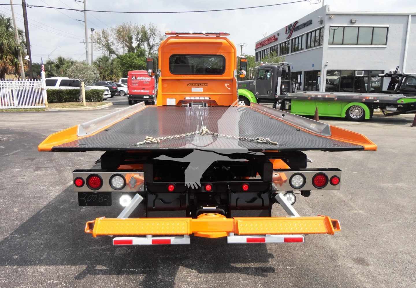 Peterbilt 337 rollback truck platform rear view with orange cab and loading ramp, new stock J06176.