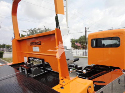 Orange JERR-DAN rollback bed with hydraulic components and cabin visible; JERR-DAN branding on the bed.