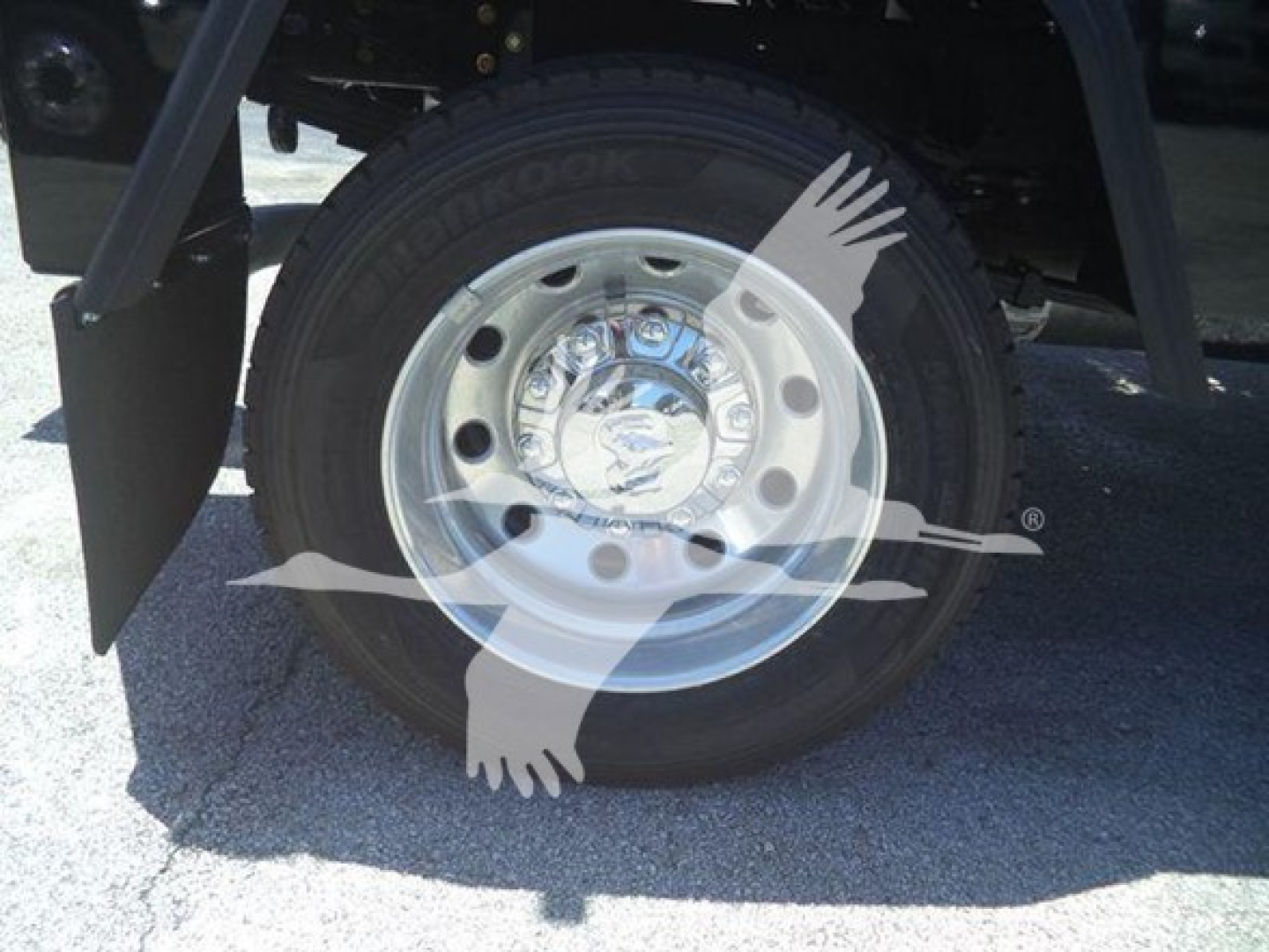 Wheel and tire on a 2024 Ram 4500 SLT truck, chrome hub with center cap, undercarriage and fender visible.