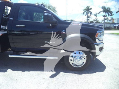 Ram 4500 pickup truck side view showing crew cab, black body, chrome wheel, side step, and RAM badge on the front door.