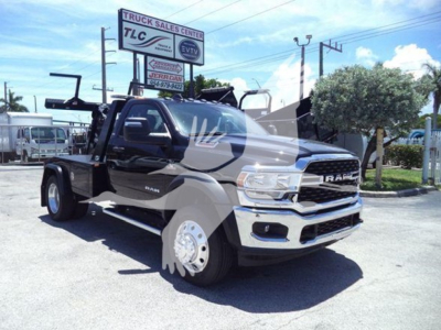 Ram 4500 SLT wrecker tow truck front-three-quarter view showing winch equipment and steel wheel hub, chrome grille, RAM badge.