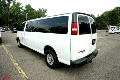 Chevrolet Express 3500 passenger van rear-right view showing white exterior and dark-tinted windows.
