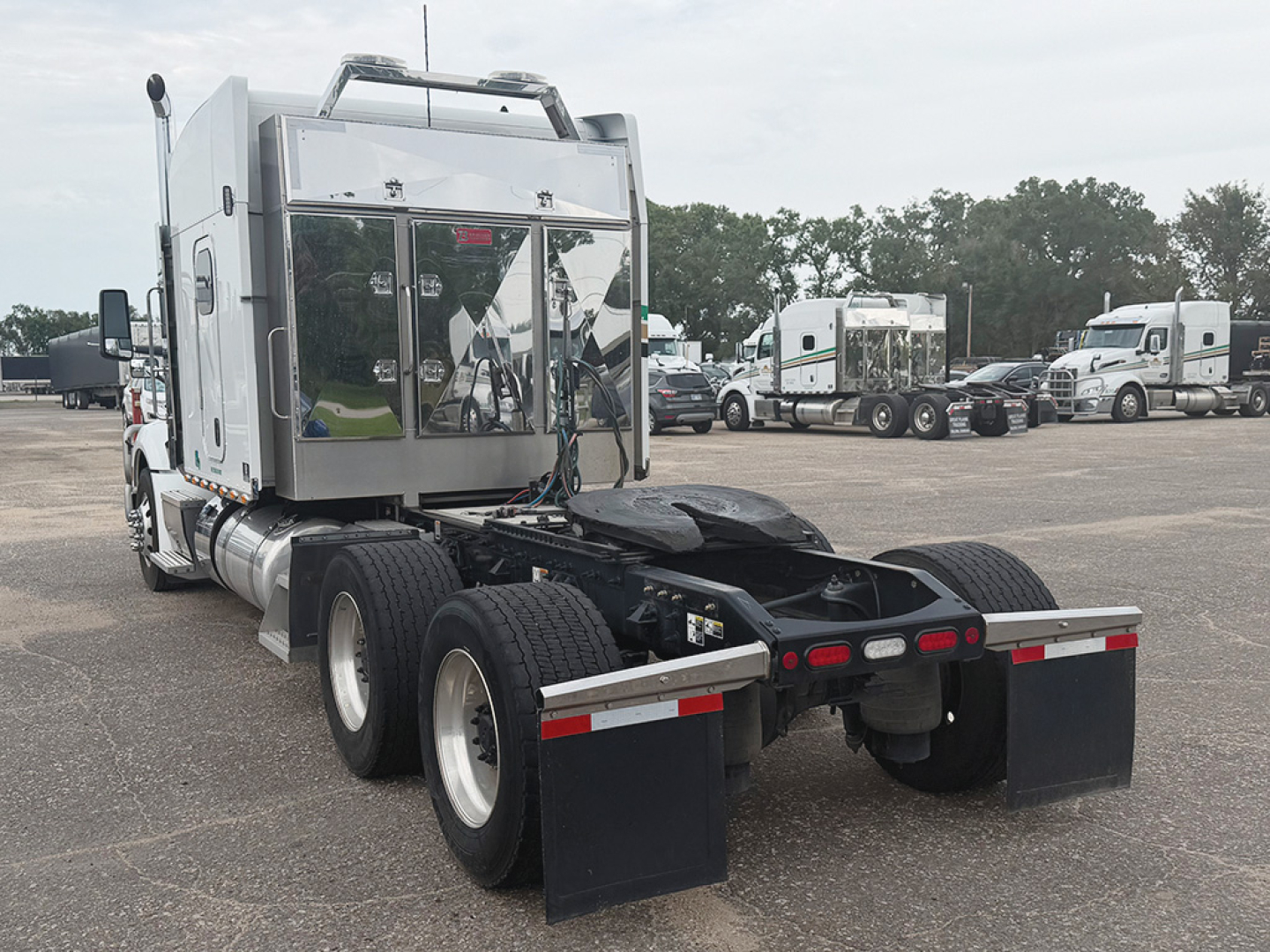 Peterbilt 579 UltraCab truck rear view showing chassis, dual rear axles, fuel tanks, and sleeper cab with chrome panels.