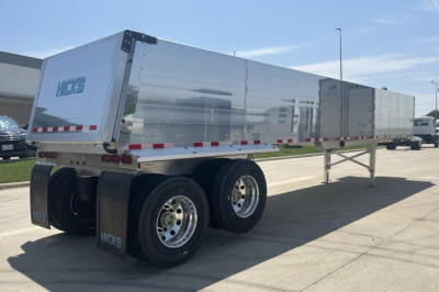 Hicks SL3729 dump trailer rear and side view showing aluminum body, dual rear wheels, and support legs. Visible text 'Hicks' on rear and wheel hubs.