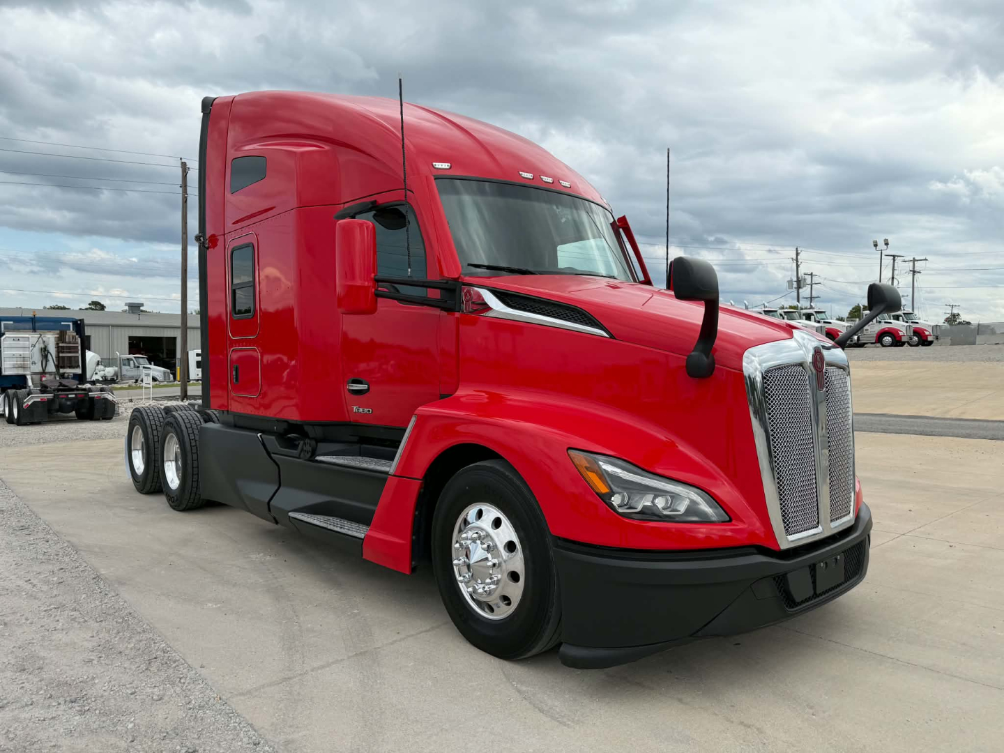 Kenworth T680 tractor in red color, side view, with sleeper cab and chrome wheels.
