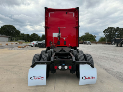 Kenworth T680 truck chassis and rear view showing tandem axle and mud flaps with MHC logos.