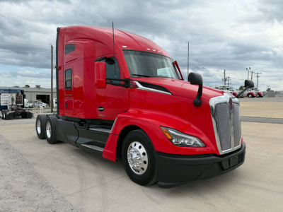 Kenworth T680 tractor in red color, side view, with sleeper cab and chrome wheels.