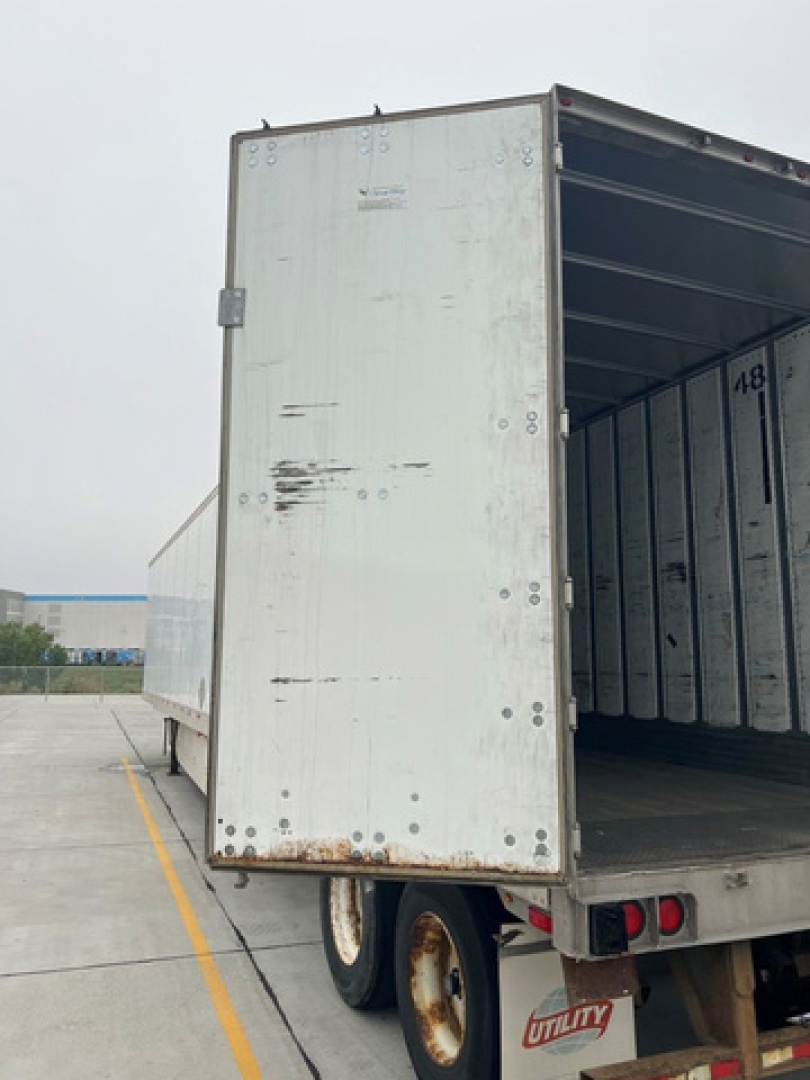 Trailer rear cargo area of a used 2014 utility van trailer showing open ramp door and interior walls, ID 1UYVS2530EP941513 and stock U91092.