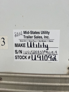 Label on trailer showing 2014 Mid-States Utility Trailer Sales, Inc. with MAKE Utility, S/N U???941613 and STOCK # U91092.