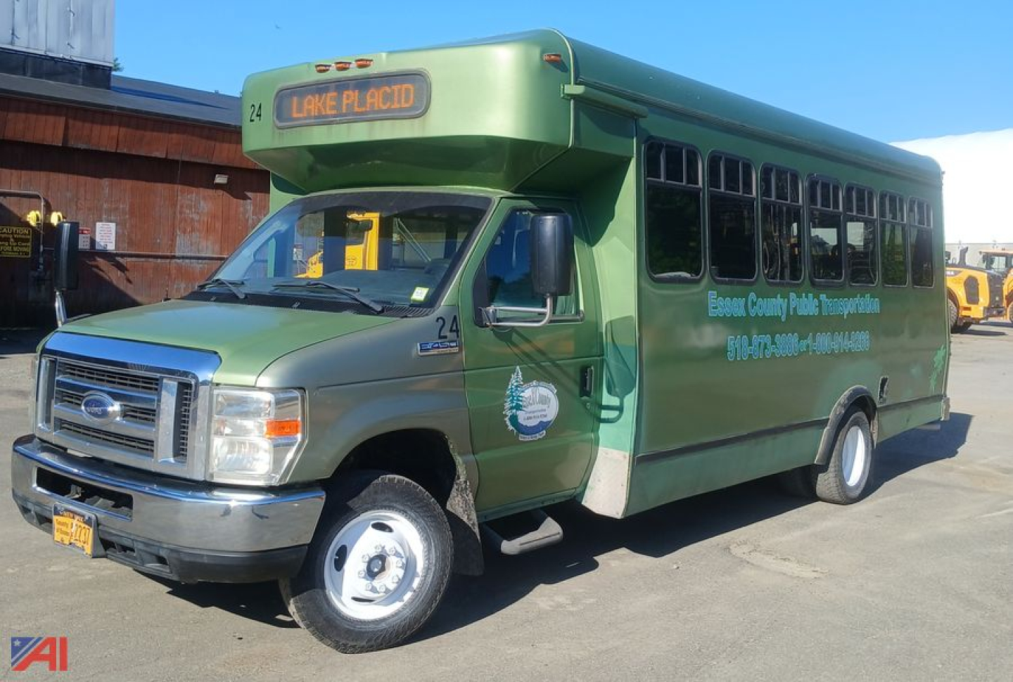 Ford E-450 shuttle bus with wheelchair lift, green body, displaying Lake Placid route number 24, side text for Everglades County Public Transport