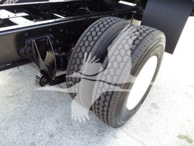 International dump truck rear axle and dual tires showing wheel and suspension components.