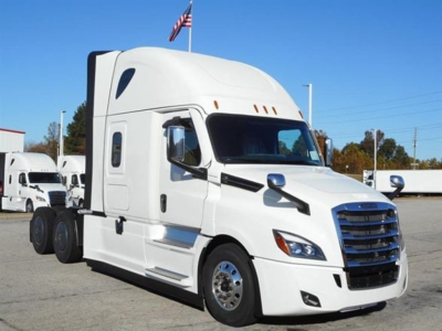 Freightliner Cascadia 126 truck in a lot showing cab and chrome wheels.