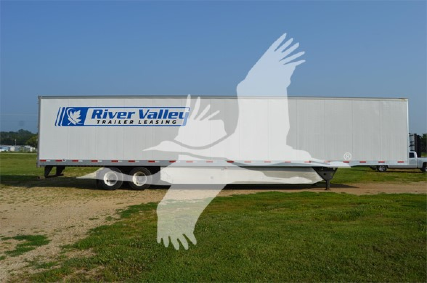  trailer showing River Valley trailer leasing logo on side of long white cargo trailer with twin axles
